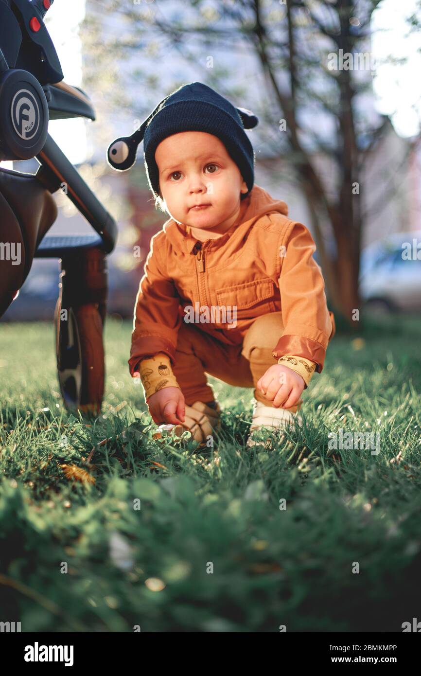 portrait of a one year old boy with a snail wool cap on the background