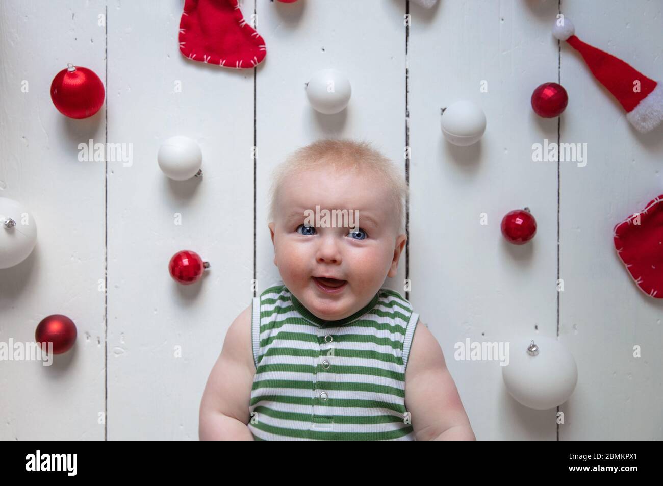 happy cute baby celebrating their first christmas Stock Photo Alamy