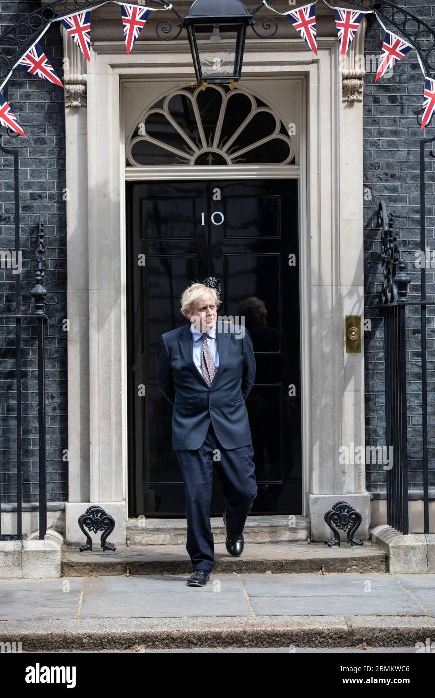 UK Prime Minister Boris Johnson steps onto the entrance of No.10 Downing Street for Victory of Europe 75th Anniversary muted Celebrations, London, UK Stock Photo