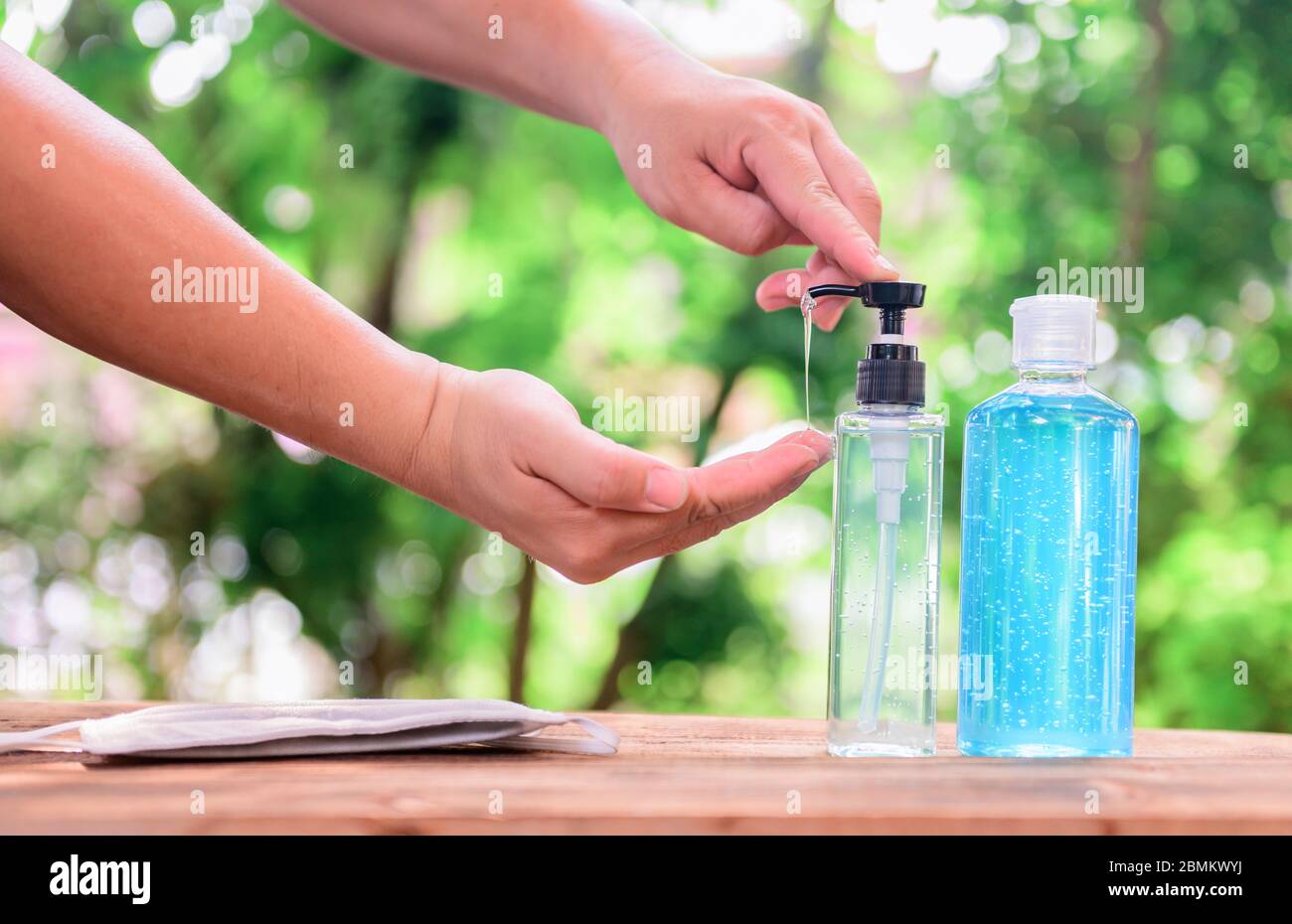 Antiseptic hand gel with alcohol. Washing hands to protect against Corona virus and stop the spread of COVID-19. Stock Photo