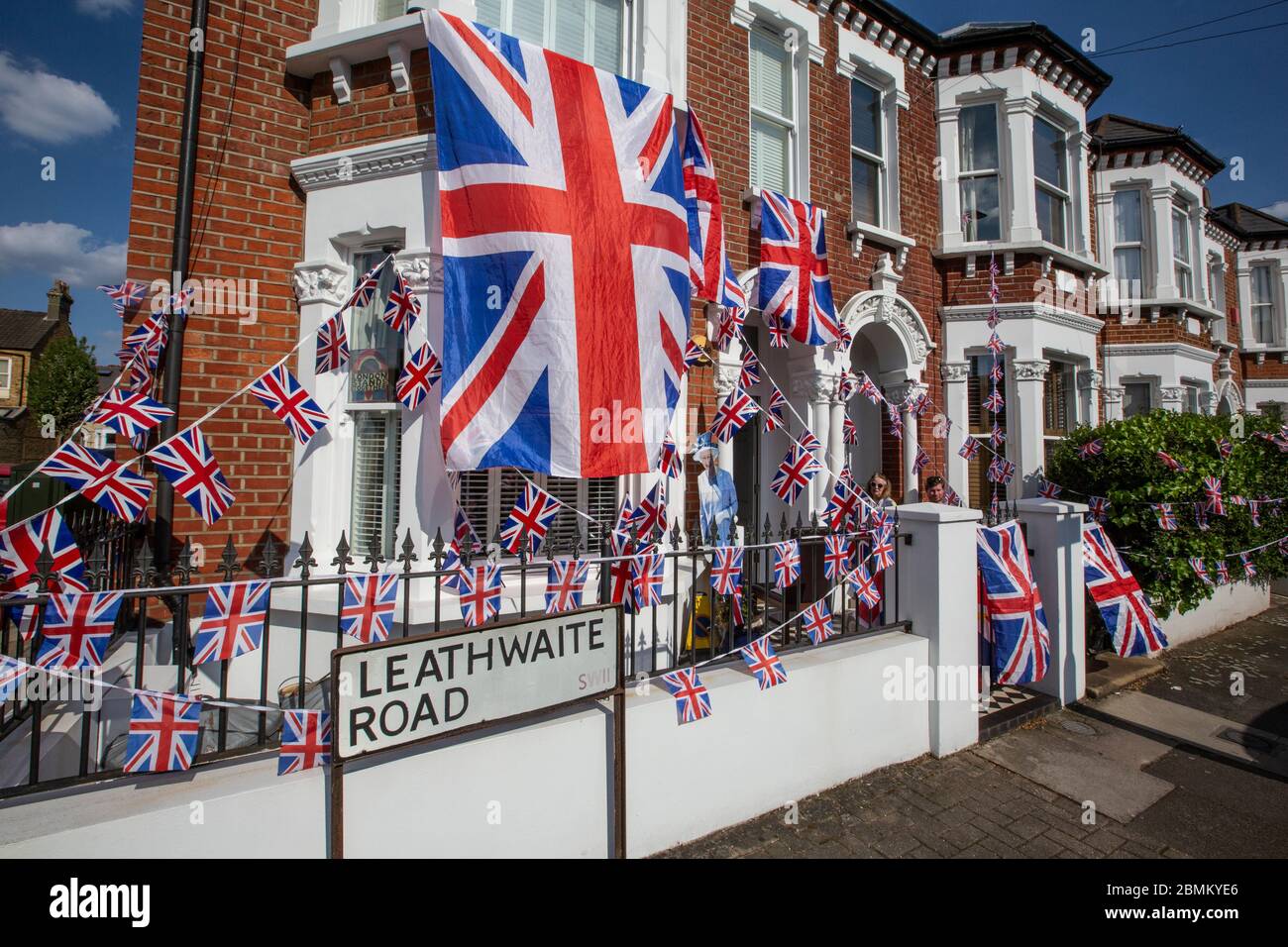 People enjoy the Victory in Europe 75th Anniversary day within the restraints of their houses during coronavirus lockdown in Clapham, Southwest London Stock Photo