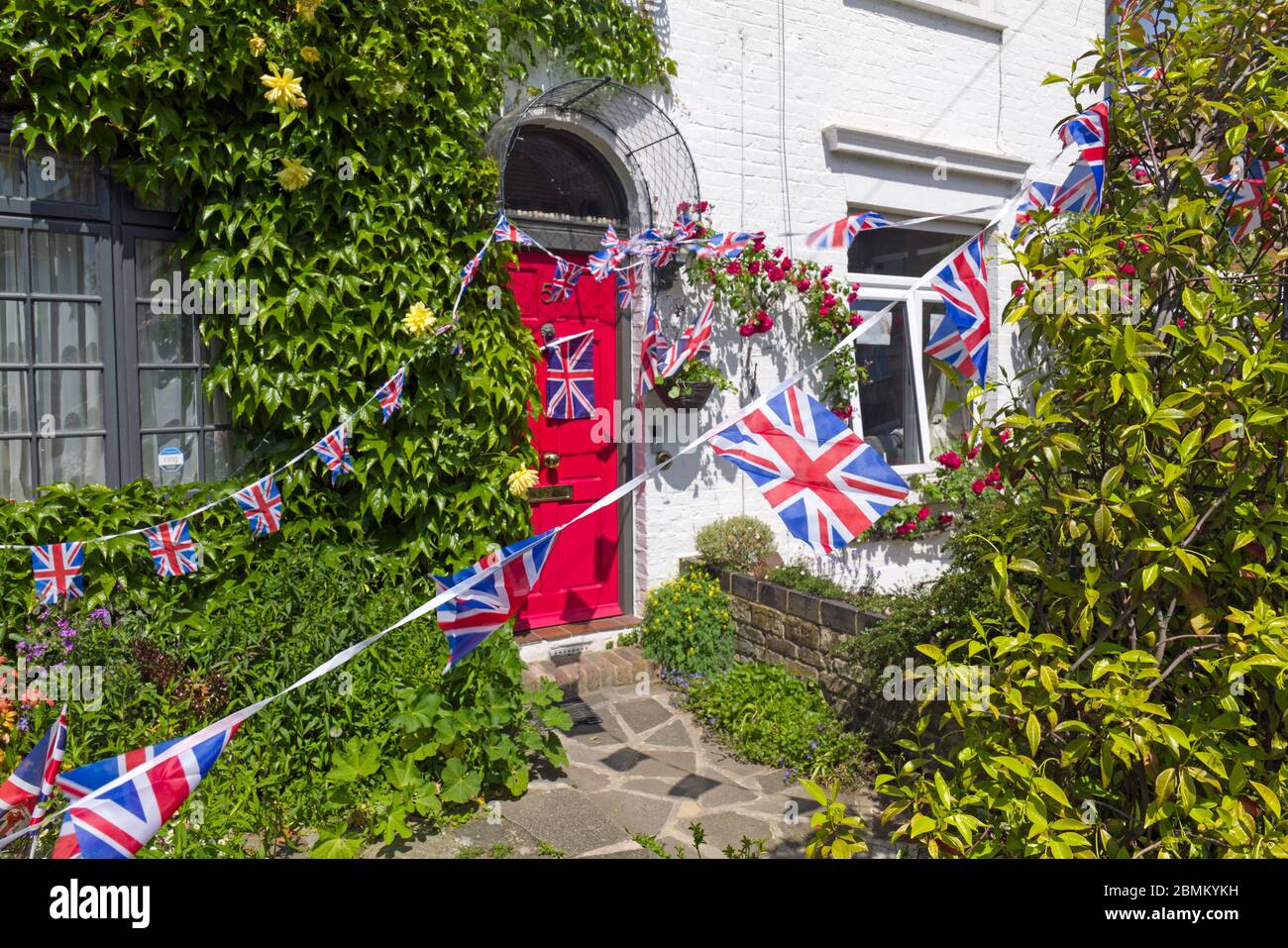 Union Jack Bunting hanging outside a house in South West London celebrating the 75th anniversary of Victory in Europe. May 2012. Stock Photo