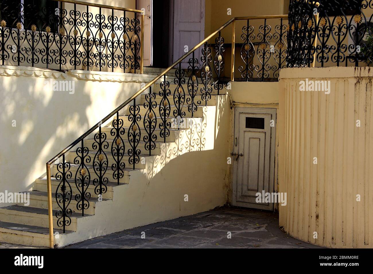 Beautifully designed and painted iron railings and latched basement ...