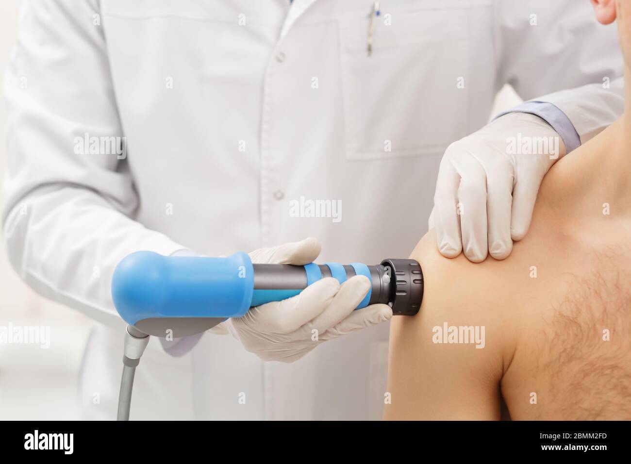 Extracorporeal Shockwave Therapy ESWT.Effective non-surgical treatment.Physical therapy for shoulder with shock waves.Pain relief, normalization and Stock Photo