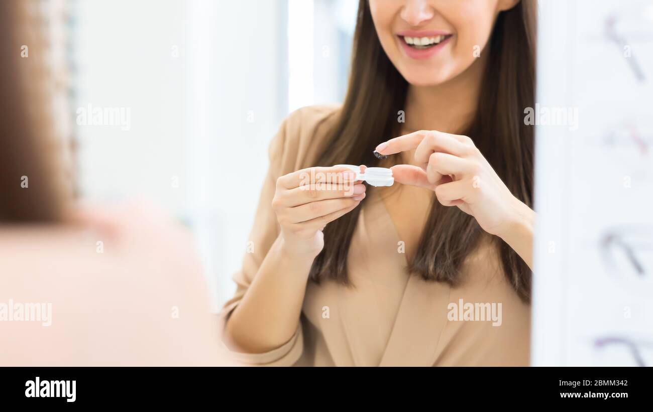Happy girl holding contact eye lenses and container Stock Photo