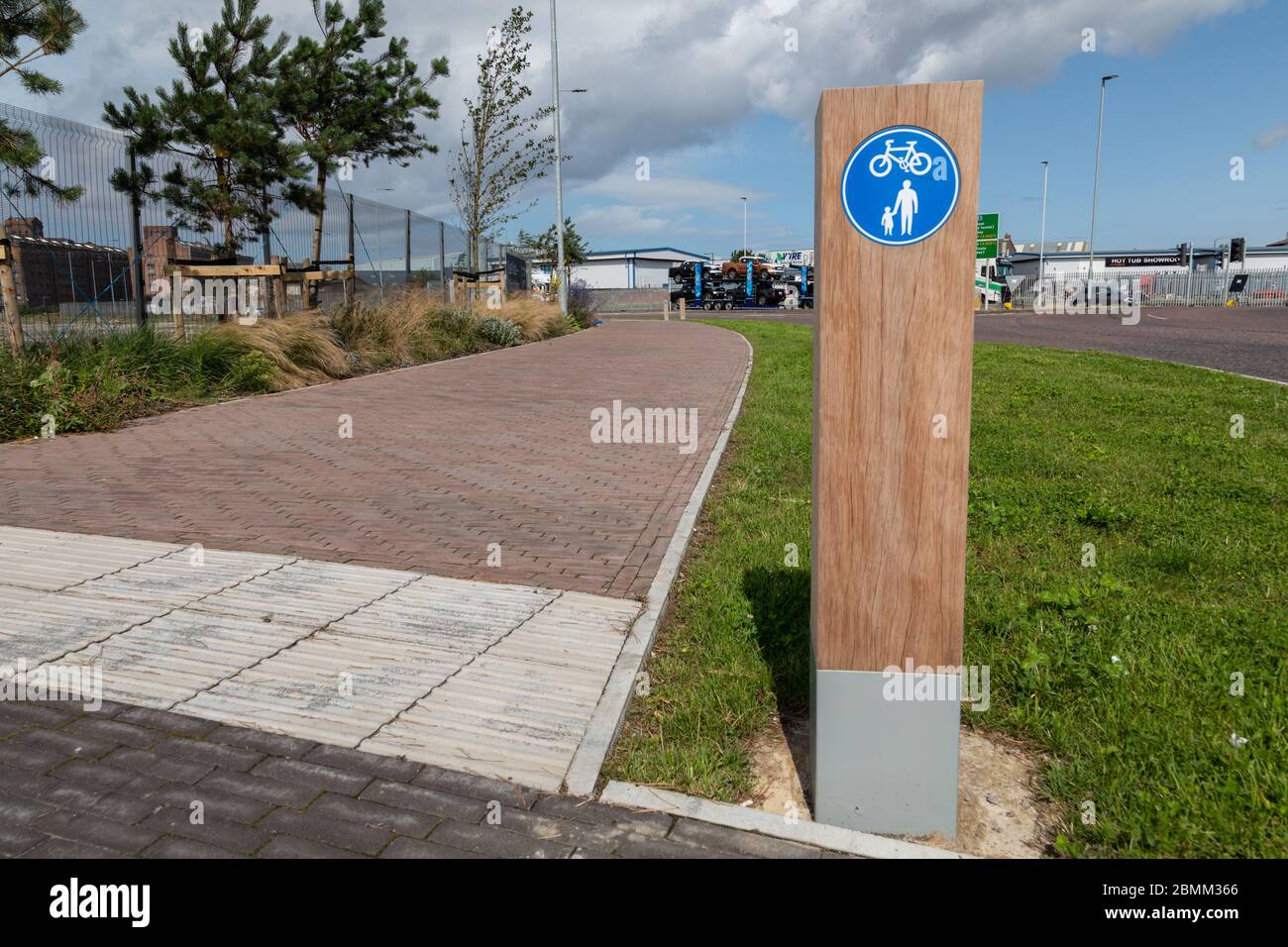 Wooden sign indicating cycle and footpath aWallasey docks Wirral August 2019 Stock Photo