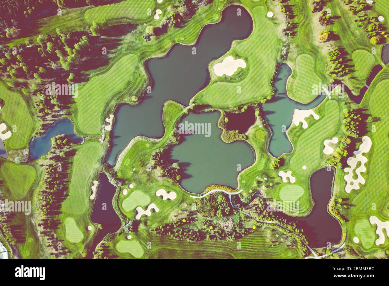 Aerial view of a golf course fairway and green with sand traps, trees ...
