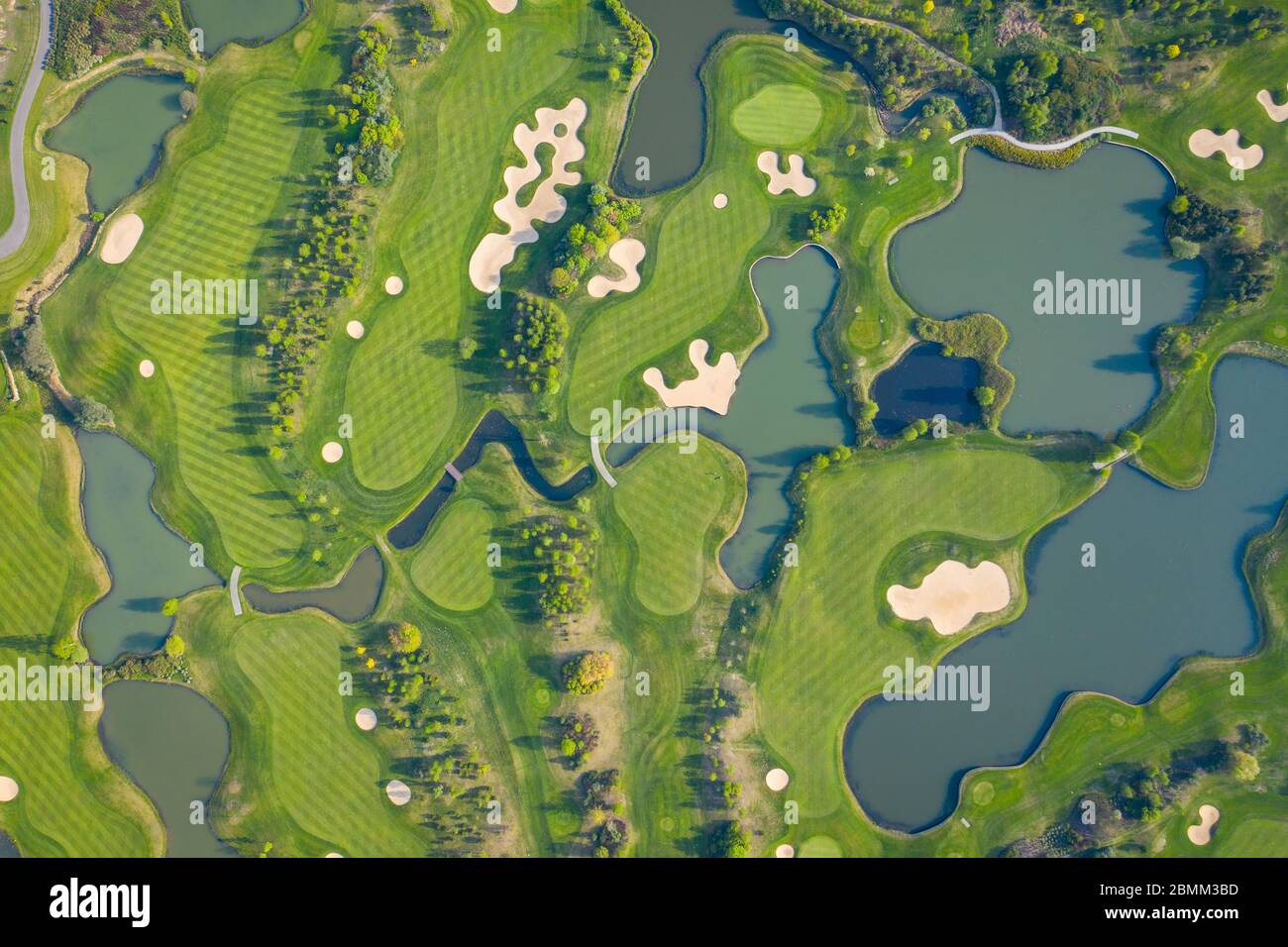Aerial view of a golf course fairway and green with sand traps, trees ...