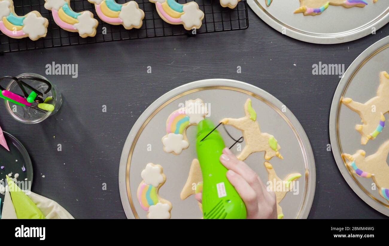 Flat lay. Step by step. Drying royal icing on unicorn sugar cookies