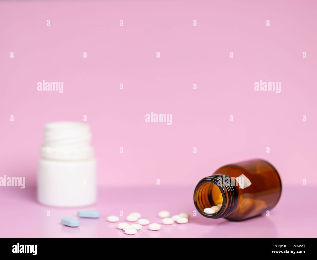 Different medications. Various pill bottles. Onecolor backdrop Stock