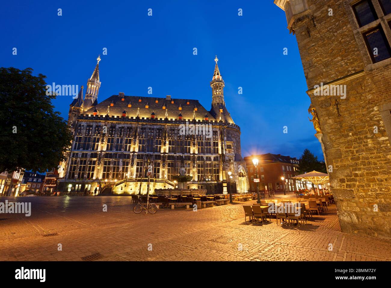 The town hall of Aachen with night blue sky and illumination in Germany seen from the market square. Stock Photo