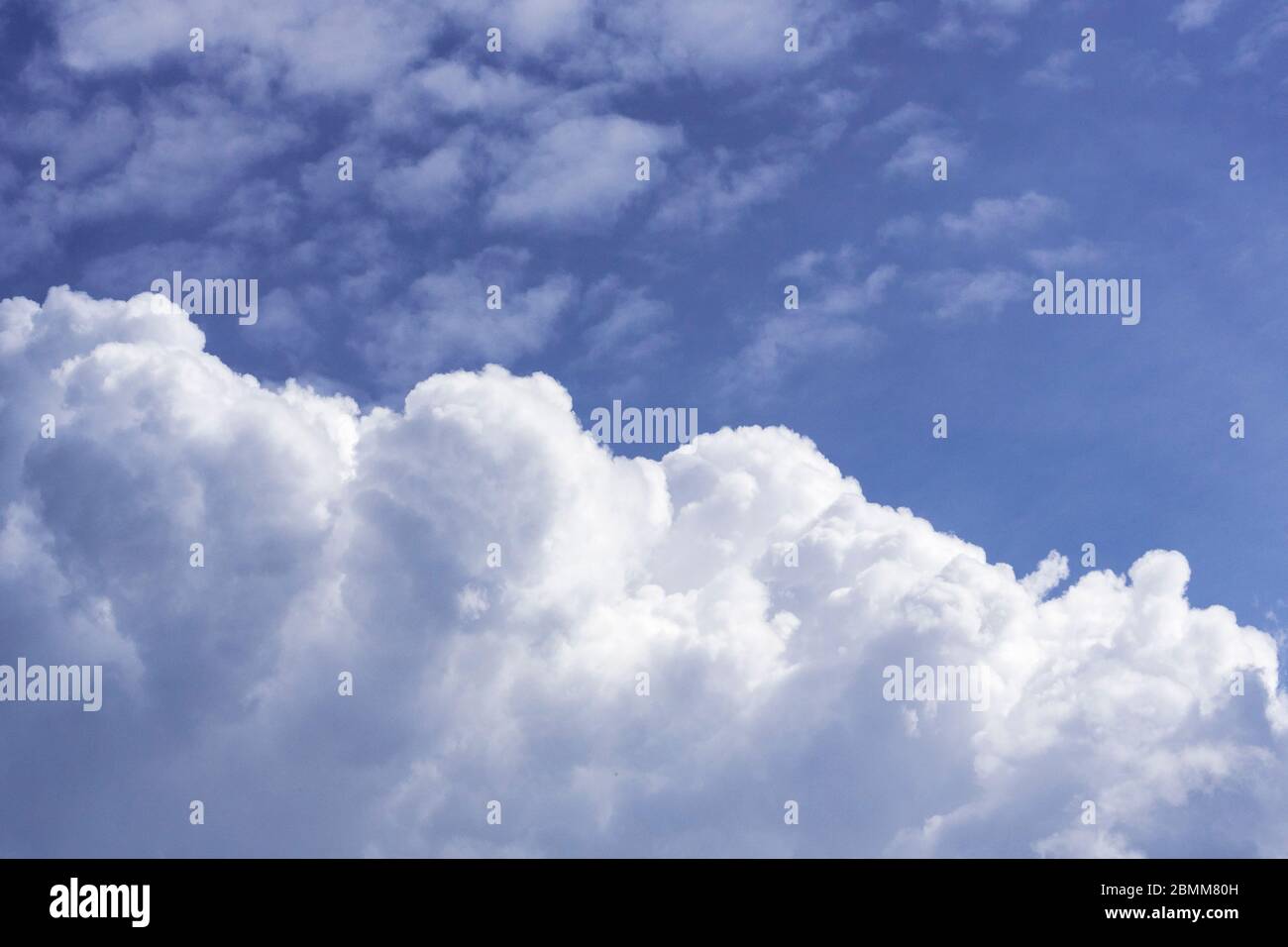 Fluffy white clouds in a blue sky. Cumulus Stock Photo - Alamy