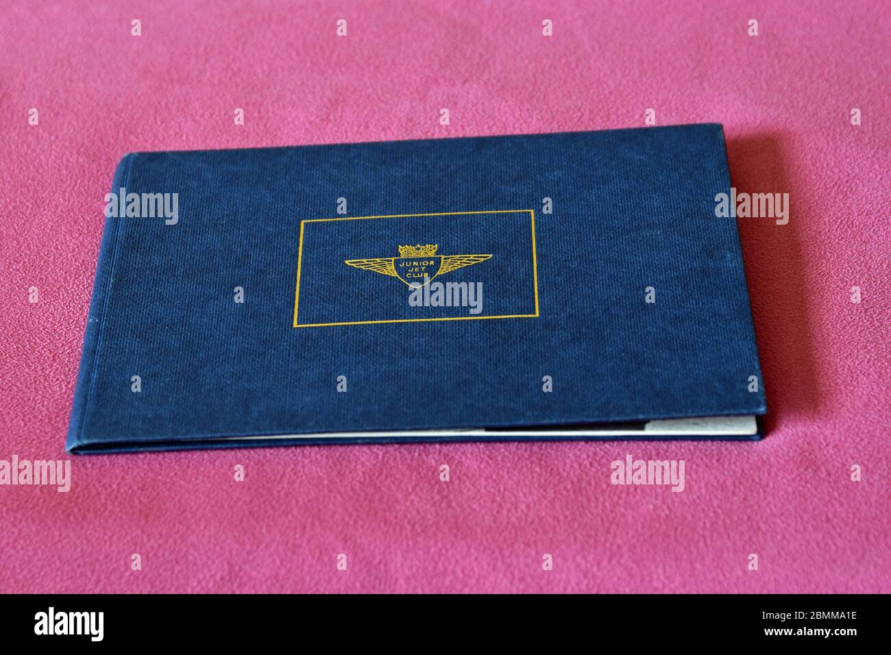 Authentic vintage junior jet club logbook from 1970s on pink fabric background Stock Photo