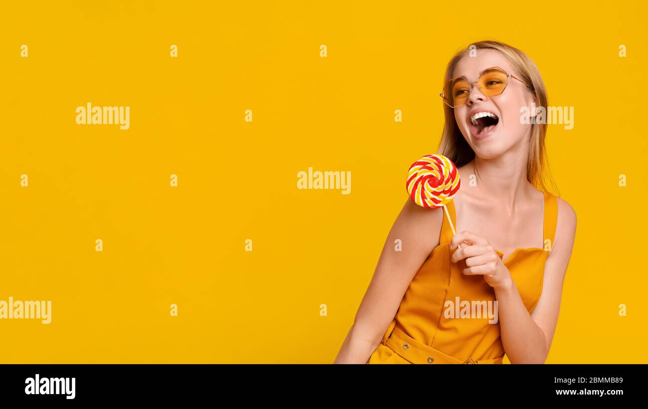 Summer Offer. Excited Young Girl With Big Lollipop Looking At Copy Space  Stock Photo - Alamy