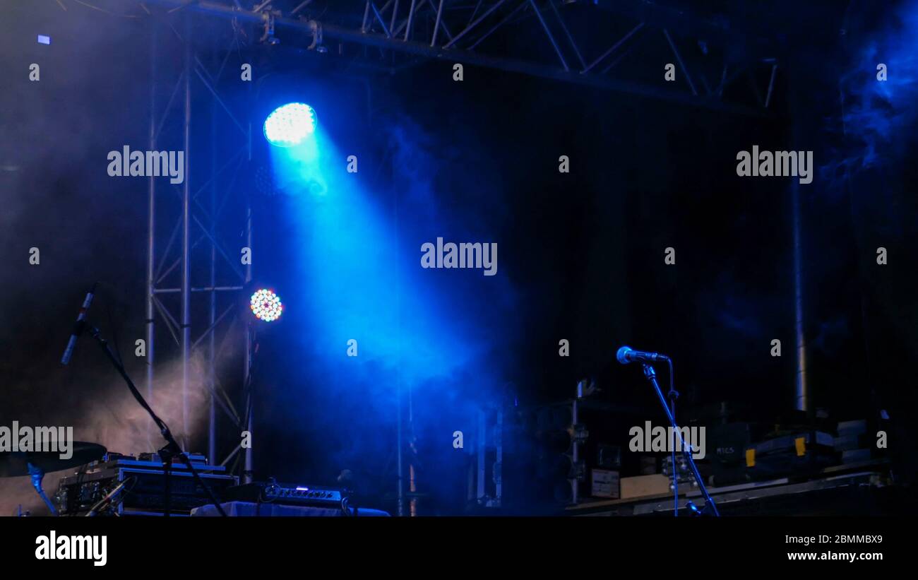 Free stage with blue lights before concert, lighting devices, microphone Stock Photo