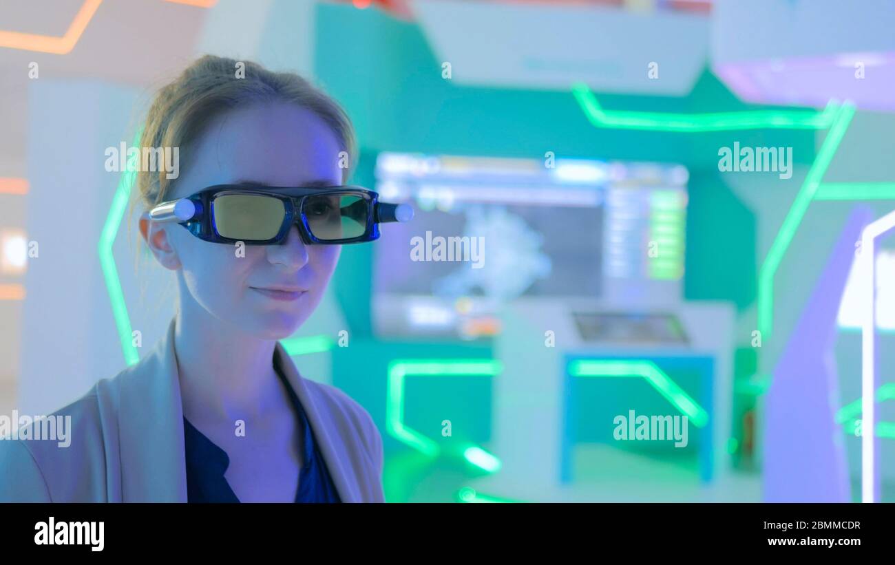 Young woman using 3d augmented reality glasses with motion sensor at ...