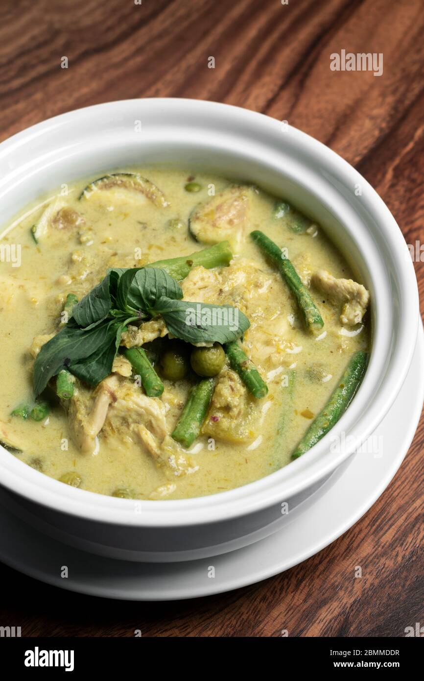thai green curry with chicken and vegetables on wood table Stock Photo