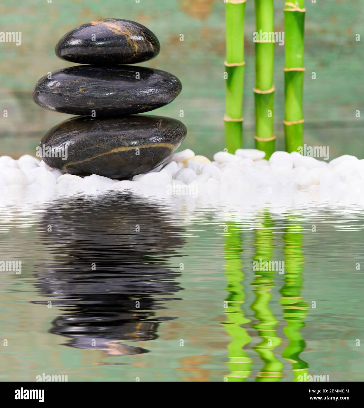 Japanese Zen garden with stacked stones mirroring in water Stock