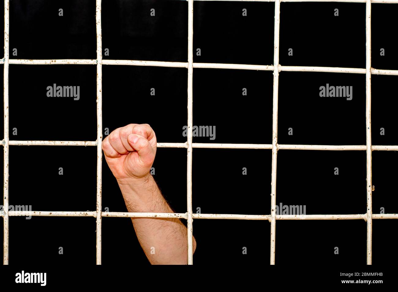 concept of limitation in the era of the quarantine pandemic human hand hold on to the iron bars Stock Photo