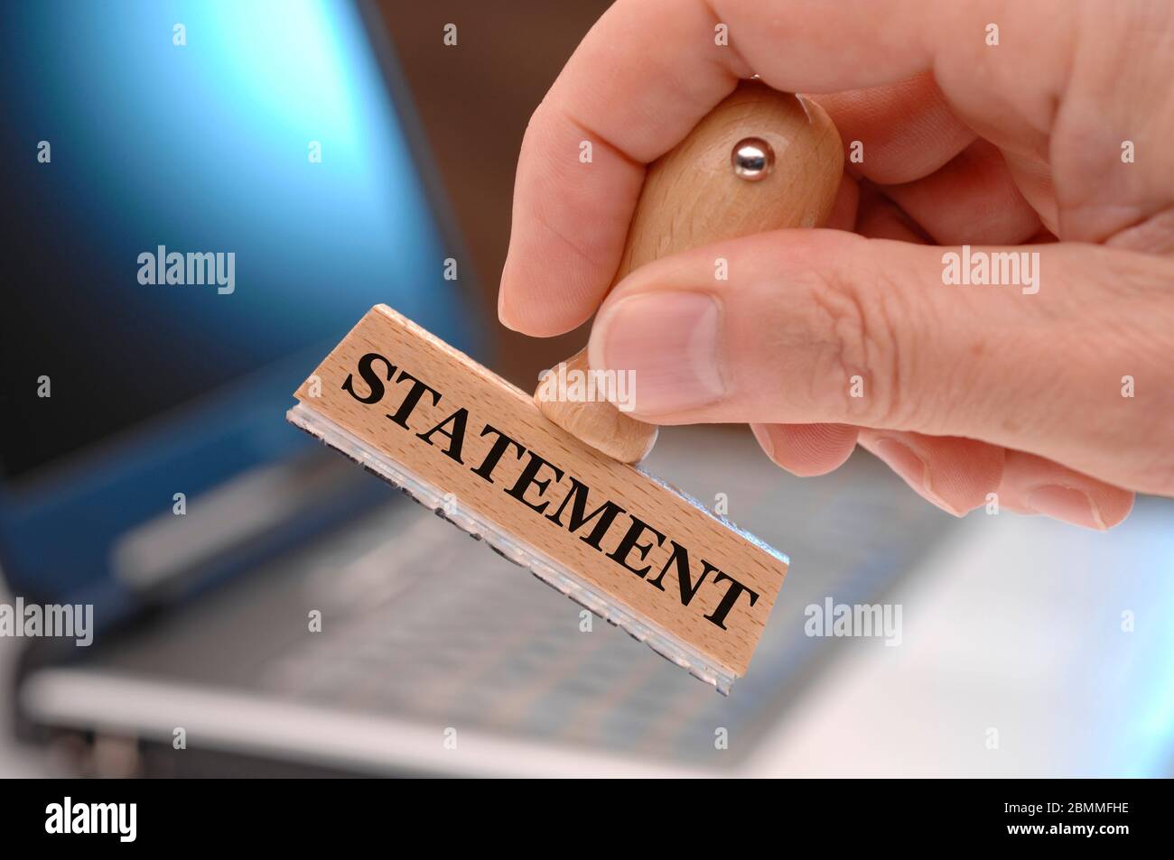 statement  printed on rubber stamp in hand Stock Photo
