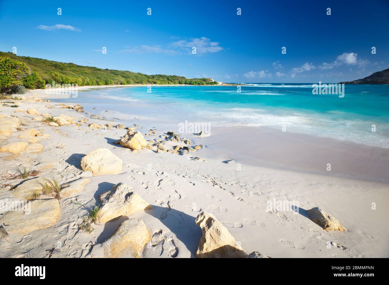Daytime long exposure of the beautiful Half Moon Bay in Antigua. Stock Photo