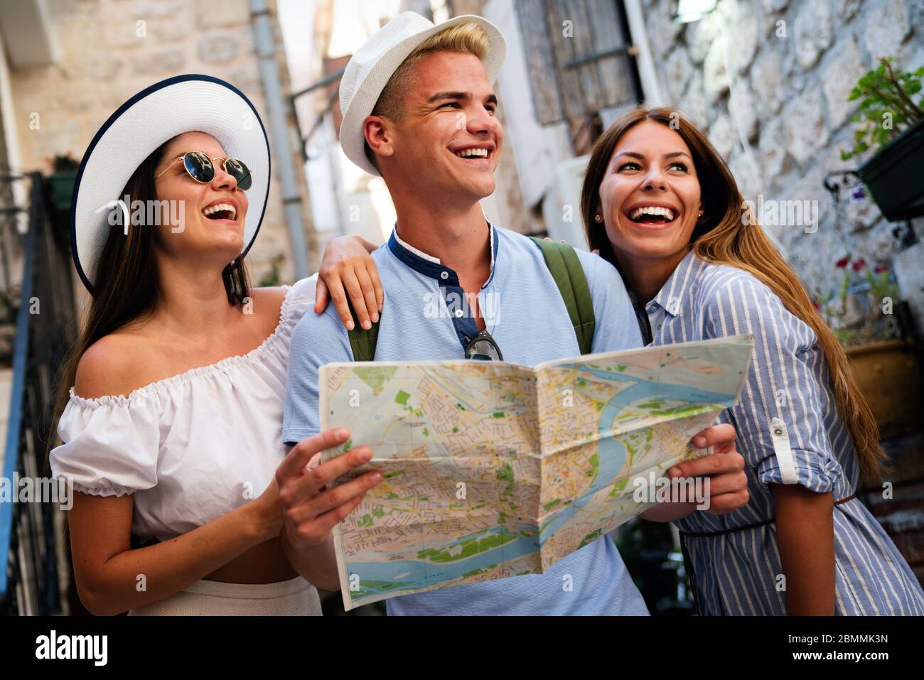 Happy traveling tourists sightseeing with map in hand Stock Photo
