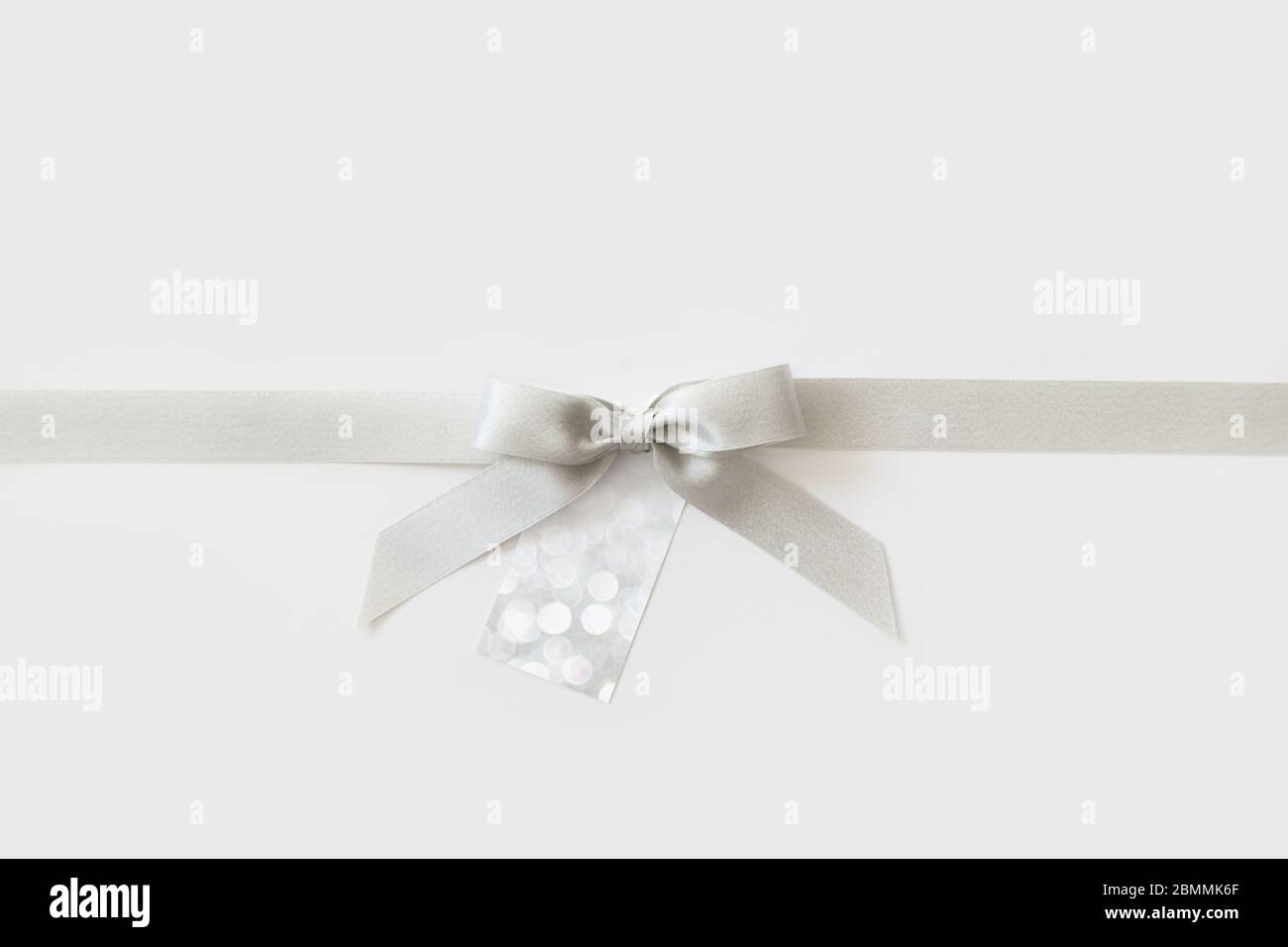 Silver ribbon with a bow as a gift on a white background Stock Photo ...