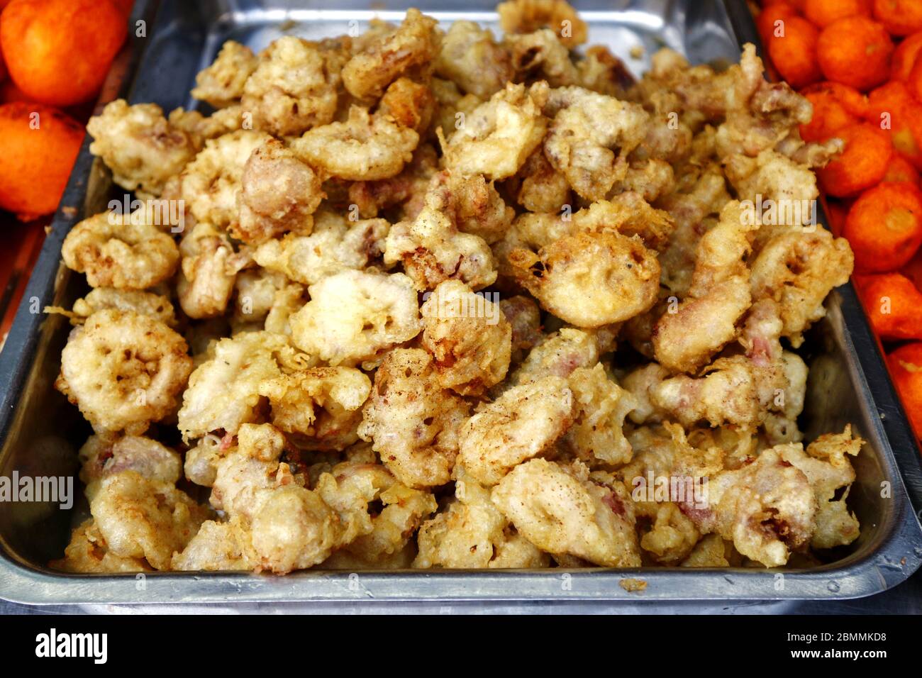 Photo of assorted deep fried street food sold at a food cart along a