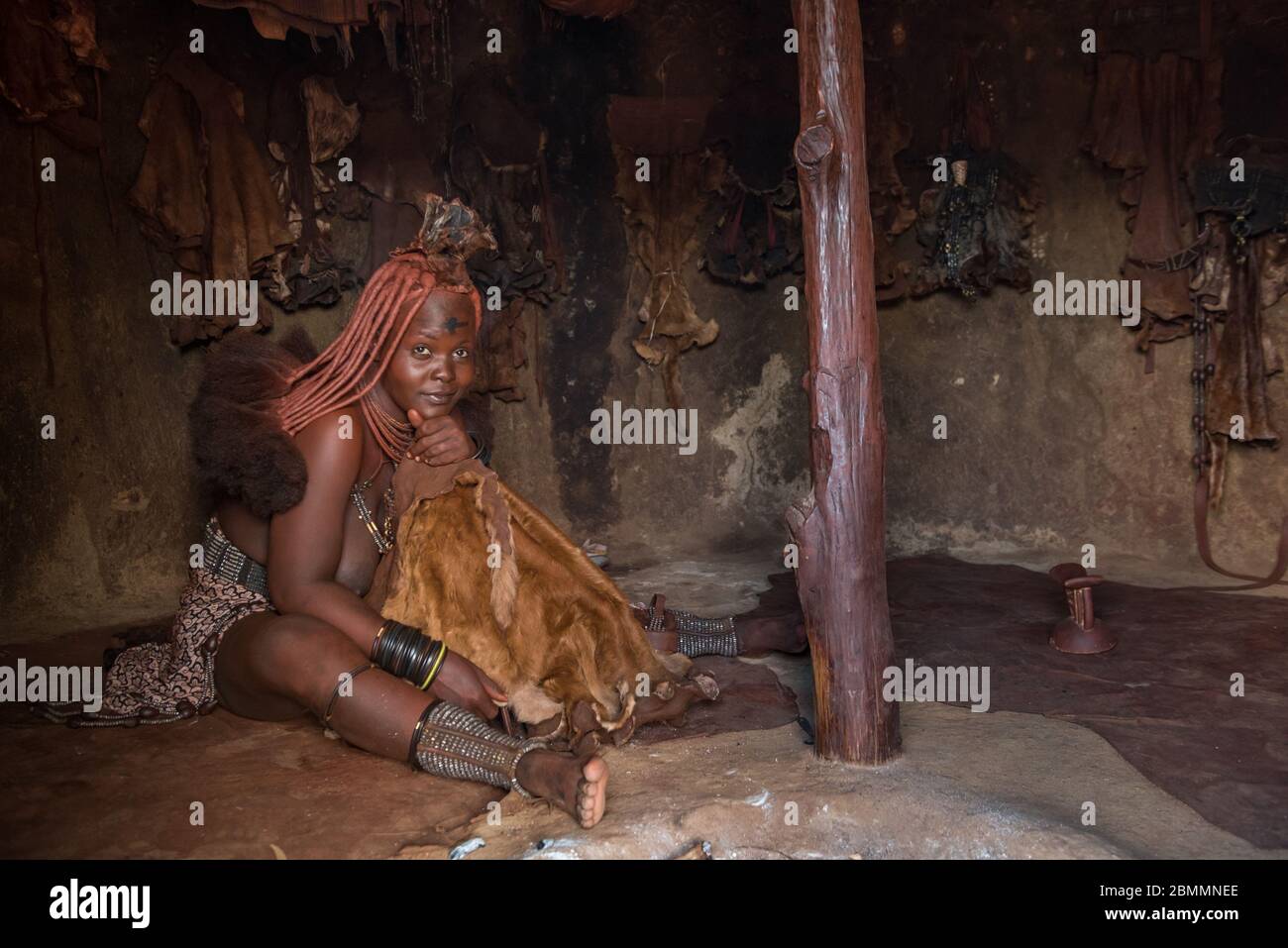 Kamanjab, Namibia - March 14, 2017: Himba woman with traditional hairstyle in Otjikandero Himba Orphanage Village Stock Photo