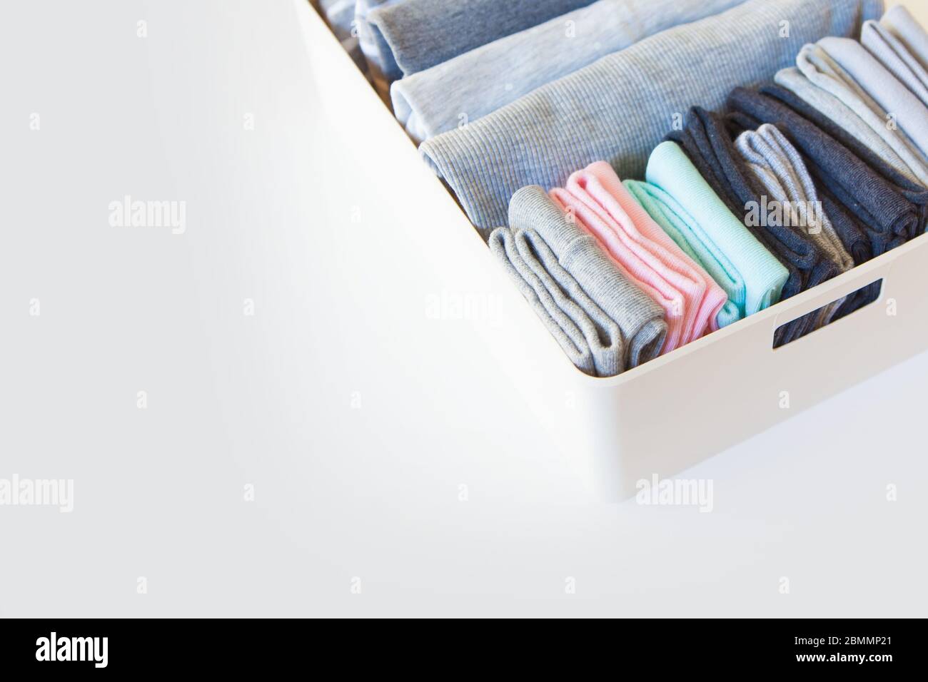 Box with brught socks, closeup. sort up socks. White background. Basket. Stock Photo