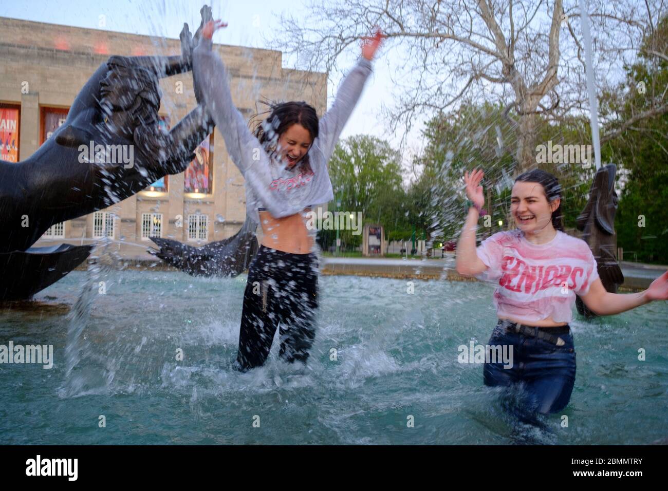 Bloomington, United States. 09th May, 2020. Two women splash water as a group of Indiana University students who just finished graduating from the Kelley School of business during a video ceremony this weekend celebrate afterwards by jumping into waters of the Show-alter Fountain and posing for photographs.Classes at IU were taught virtually since spring break due to the COVID-19/Coronavirus pandemic, and in person classes were cancelled and the in person annual graduation ceremony was also cancelled. Credit: SOPA Images Limited/Alamy Live News Stock Photo