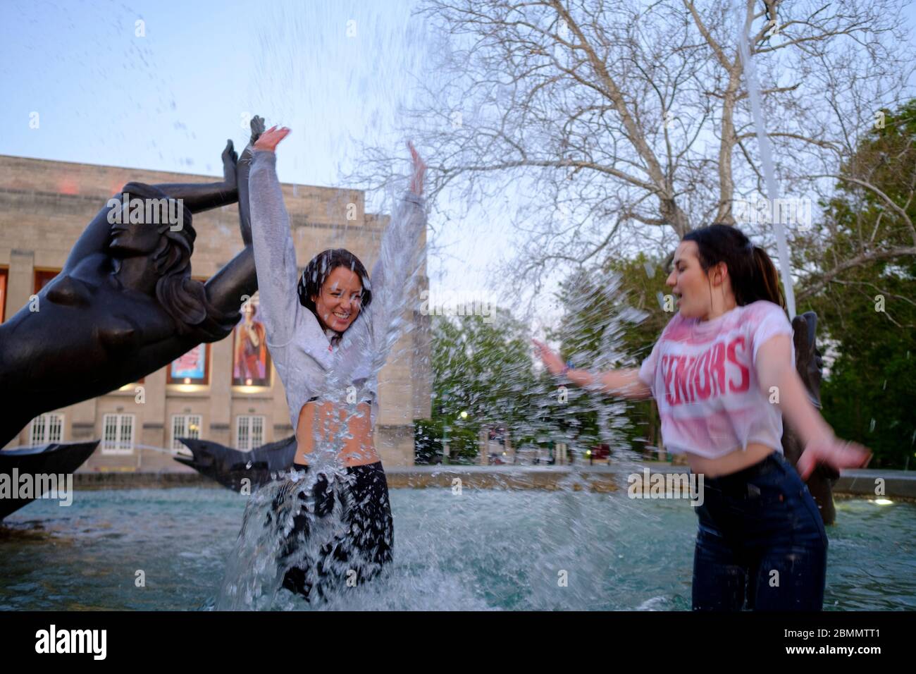 Bloomington, United States. 09th May, 2020. Two women splash water as a group of Indiana University students who just finished graduating from the Kelley School of business during a video ceremony this weekend celebrate afterwards by jumping into waters of the Show-alter Fountain and posing for photographs.Classes at IU were taught virtually since spring break due to the COVID-19/Coronavirus pandemic, and in person classes were cancelled and the in person annual graduation ceremony was also cancelled. Credit: SOPA Images Limited/Alamy Live News Stock Photo