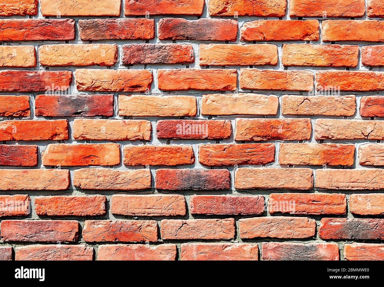 Old weathered red brick wall as background. Bricks masonry with seams Stock Photo
