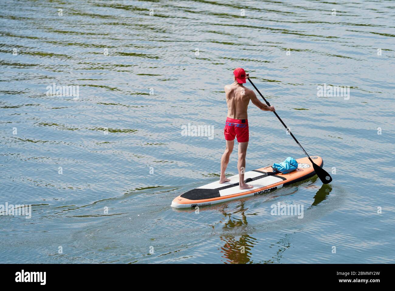 Heidelberg, Germany. 10th May, 2020. A stand up paddler crosses the
