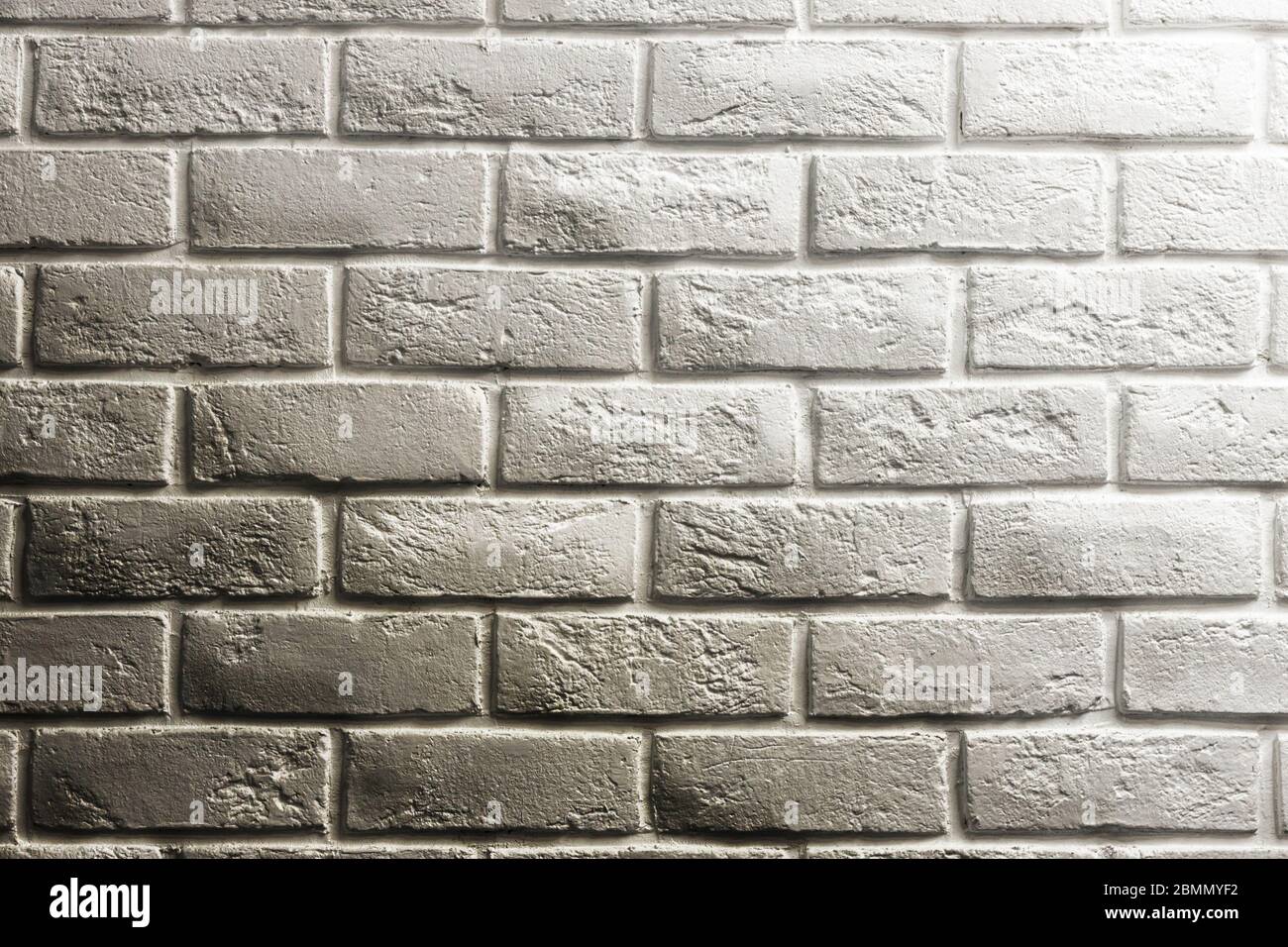 White brick wall, shadow and gradients, volume, from white to gray. Texture background for design and layouts. Stock Photo