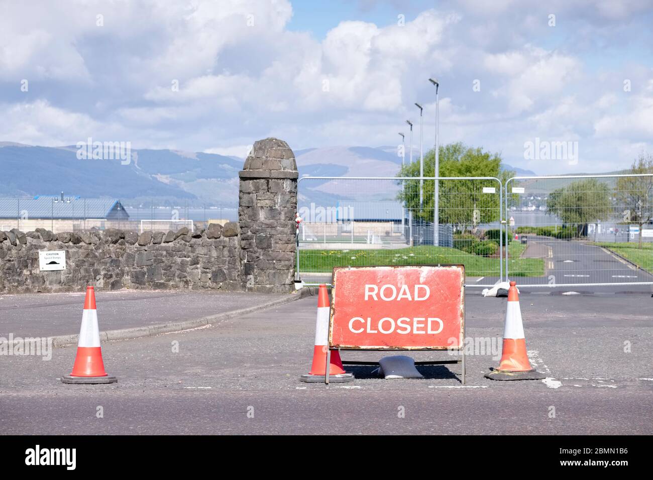 Road ahead closed and local access only sign and red traffic cones