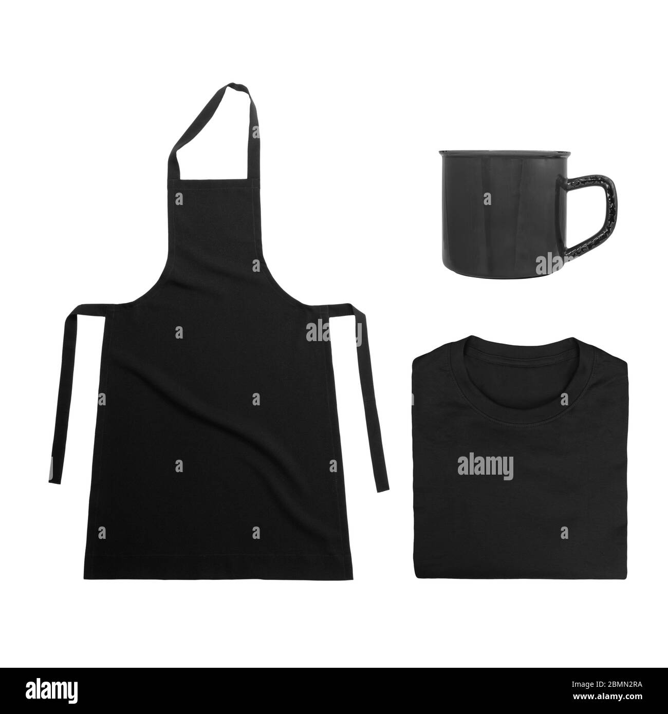 Collection of black objects isolated on white background. Black blank apron, black folded t-shirt, metal mug. Flat lay Stock Photo
