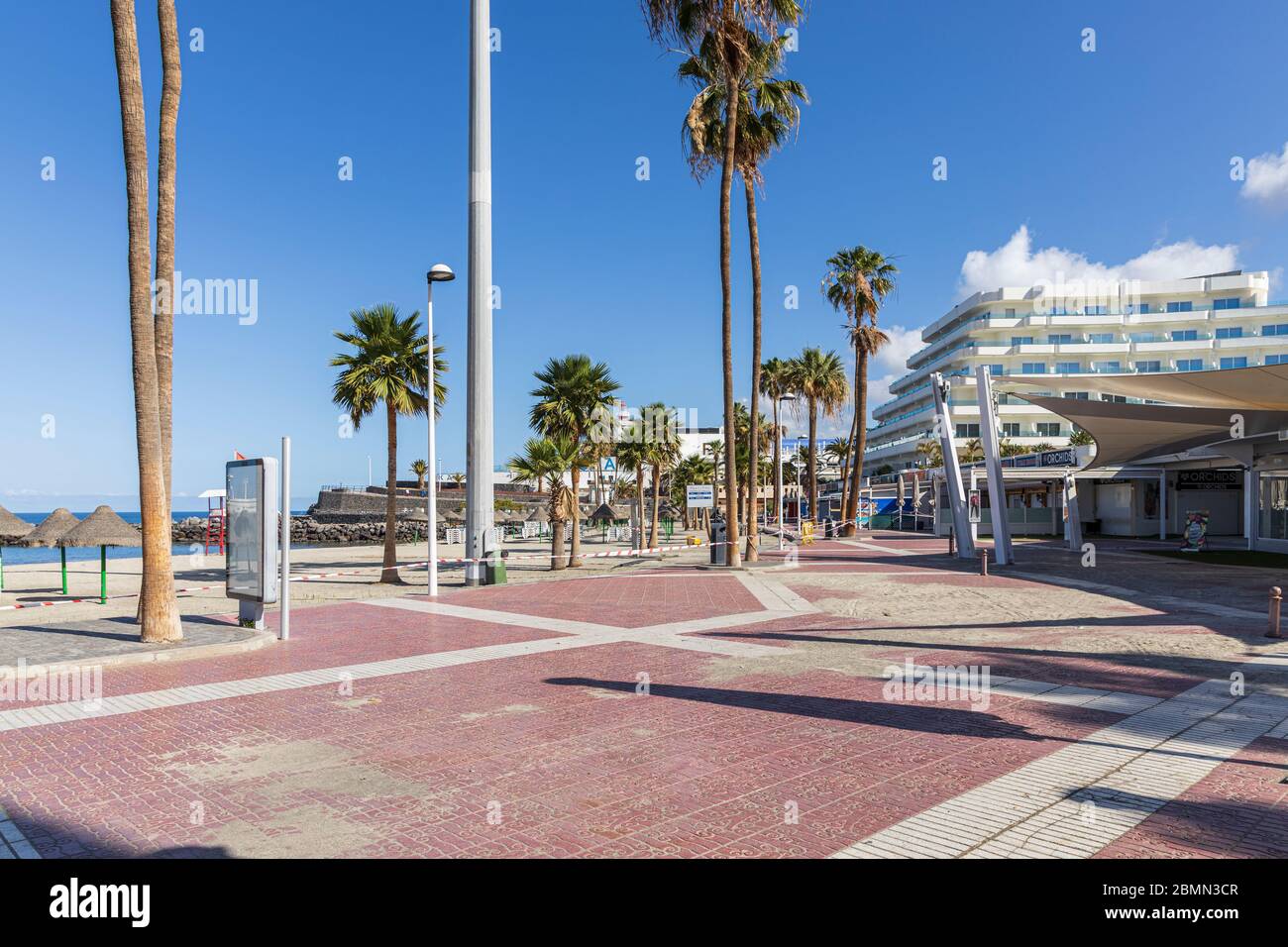 Sand from the beach on the promenade by closed bars and restaurants during the covid 19 lockdown in the tourist resort area of Costa Adeje, Tenerife, Stock Photo