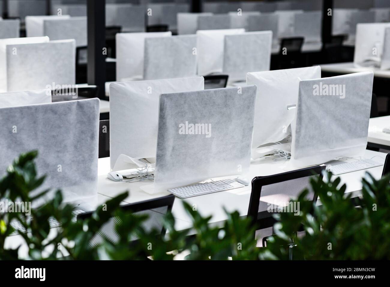Big office with covered computers with no workers Stock Photo