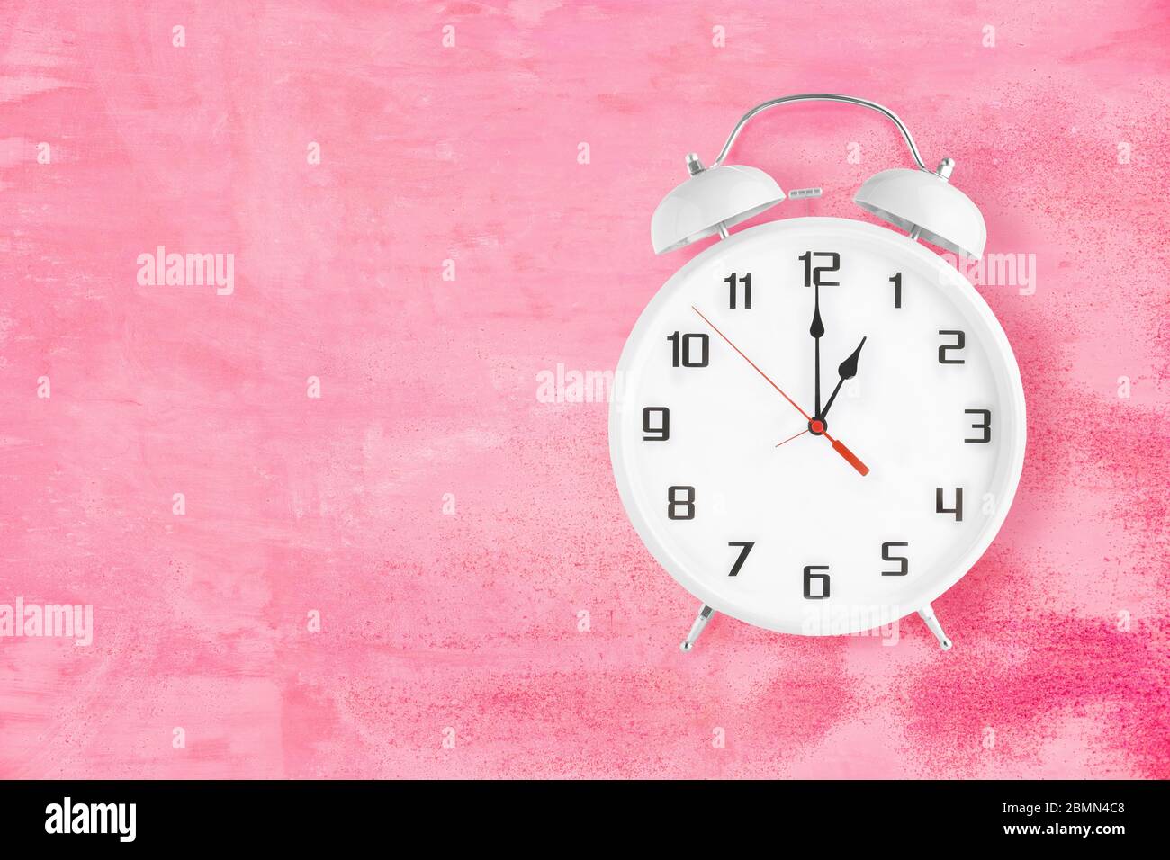 Old fashioned alarm clock with twin bells and ringer showing 1 one o