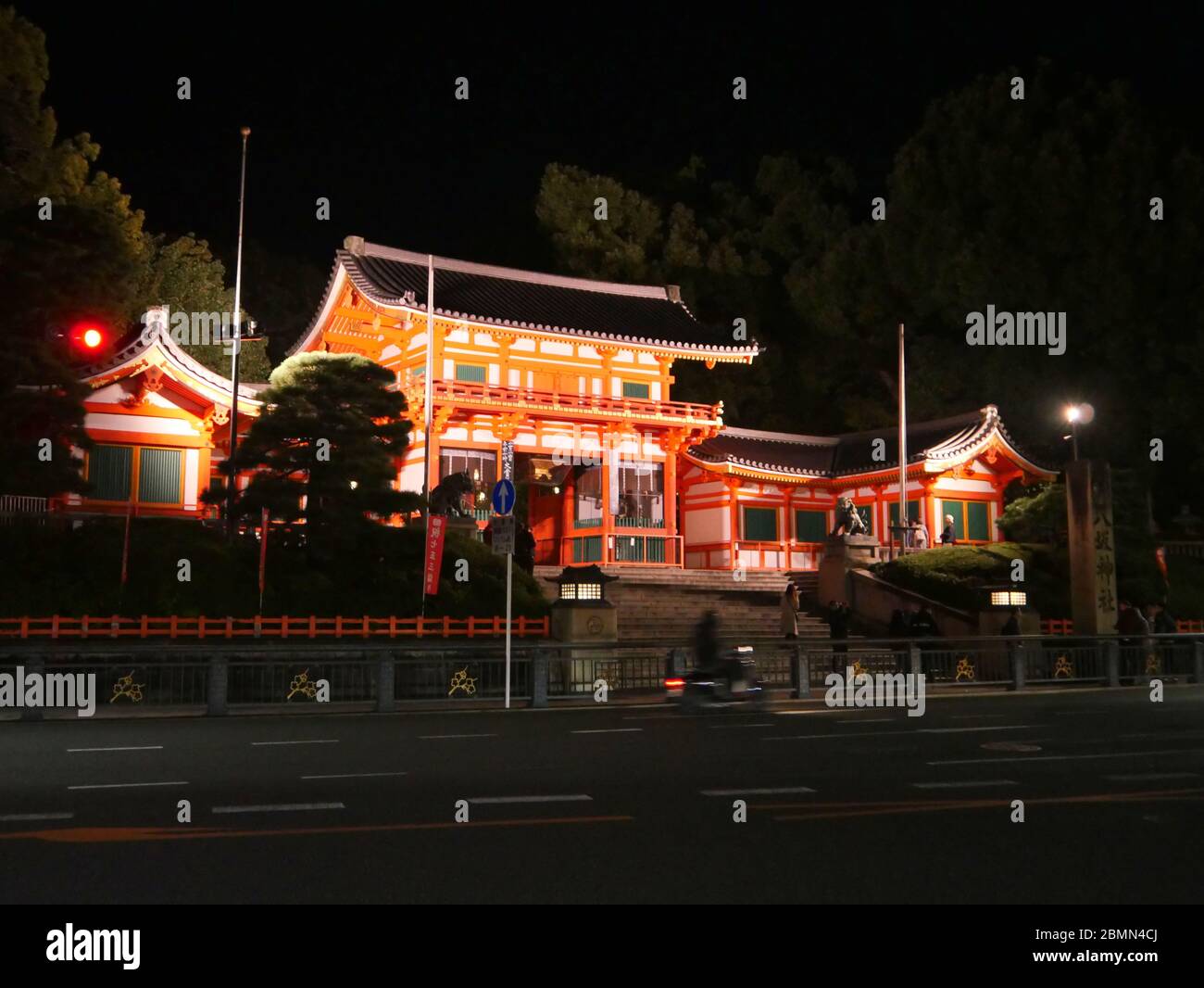 KYOTO, JAPAN - NOVEMBER 06, 2019: A fast moving motorbike in front of the gate of Yasaka Shrine or Gion Shrine in Kyoto at night Stock Photo