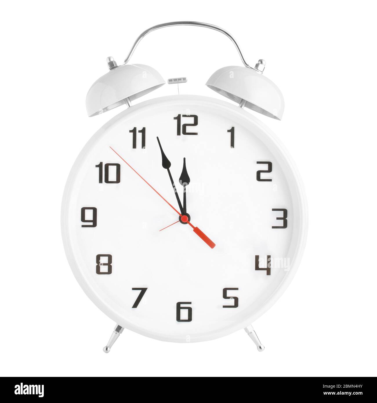 White old-fashioned alarm clock showing 5 five minutes to 12 twelve o'clock isolated on white background Stock Photo