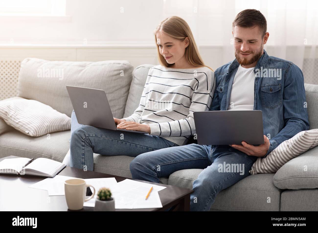 Young couple studying and playing video games on laptops Stock Photo Alamy