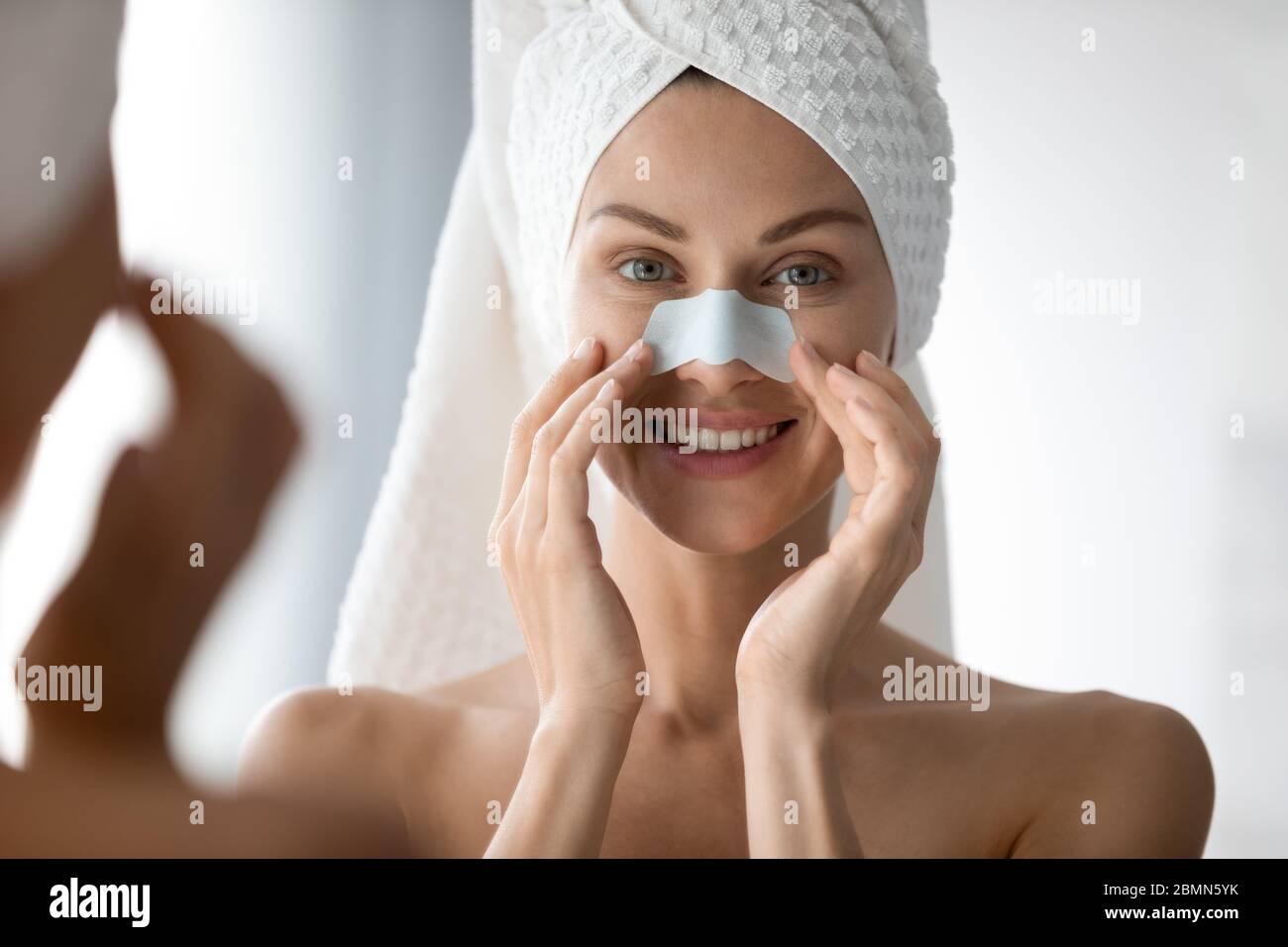 Woman using deep cleansing pore nasal strips anti blackheads treatment Stock Photo