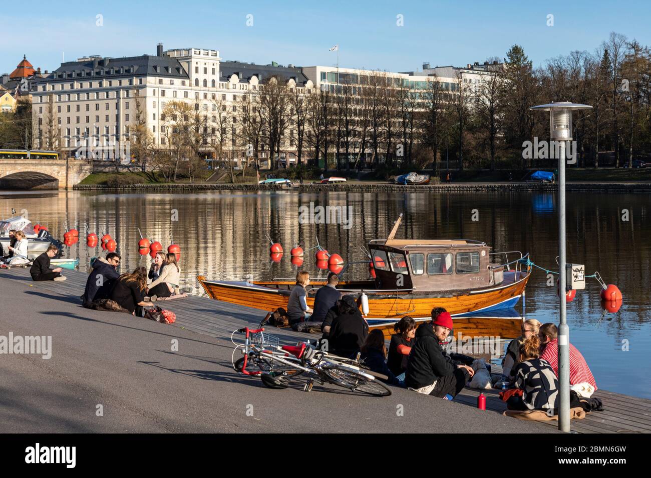 People enjoying warm spring evening on Siltasaari pier in Helsinki, Finland Stock Photo