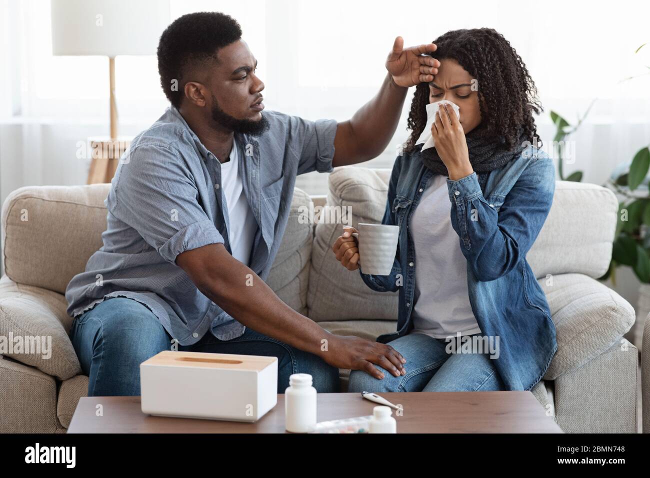 Loving African Husband Caring About His Sick Wife At Home Stock Photo