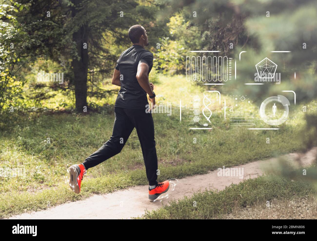 African american man running in forest with activity indicators on smartwatch Stock Photo