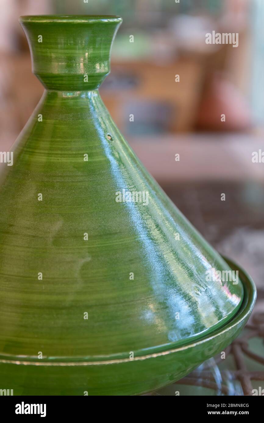 Green, traditional Moroccan ceramic tagine (tajine). Authentic, traditional expensive, high-quality ceramic that can be used for cooking. Exclusive ha Stock Photo