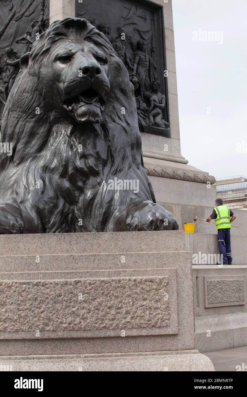 London, UK: a council worker in high-vis cleans the base of Nelson's Column in Trafalgar Square. Key workers have often not been provided with personal protective equipment and unions are concerned about safety issues if lockdown regulations are relaxed. Anna Watosn/Alamy Live News Stock Photo