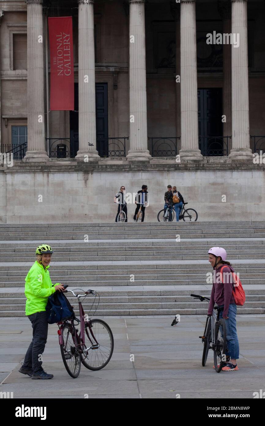 London, UK:two women cyclists in Trafalgar Square stop for photos and mostly manage to follow social-distancing advice. Prime Minister Boris Johnson is poised to announce some relaxation of the rules. Anna Watson/Alamy Live News Stock Photo